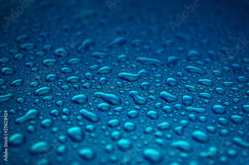 Rain drops on a blue smooth surface.