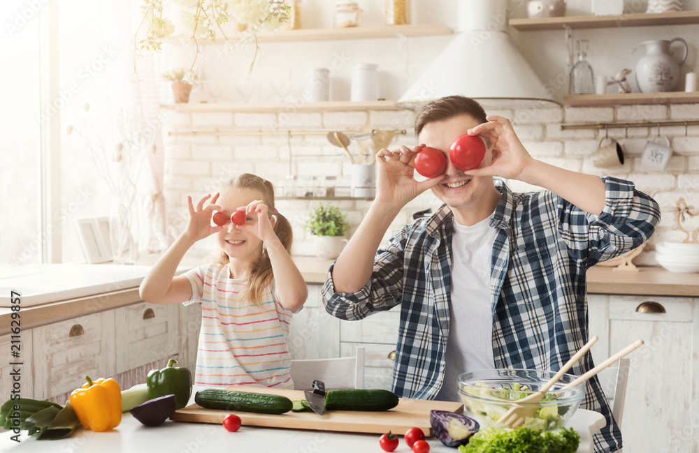 Happy father and his daughter having fun at kitchen Happy father and his daughter having fun at kitchen