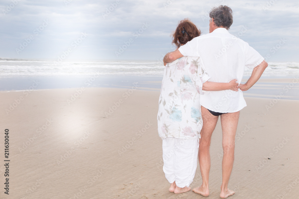 full back view couple senior retired man and woman spend time at beach