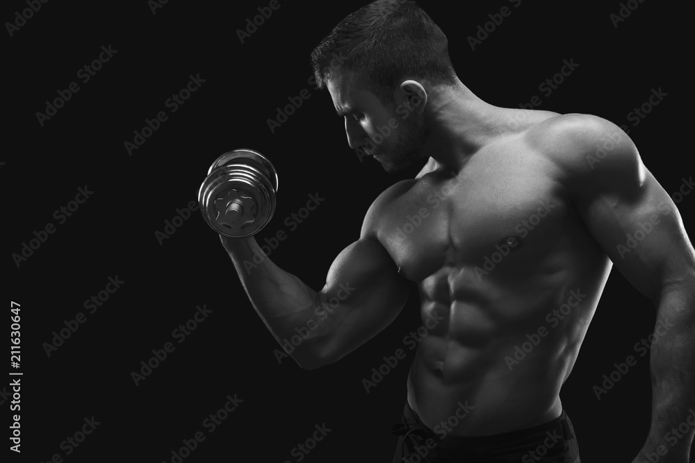 Strong man with dumbbell showing muscular body Strong man with dumbbell showing muscular body