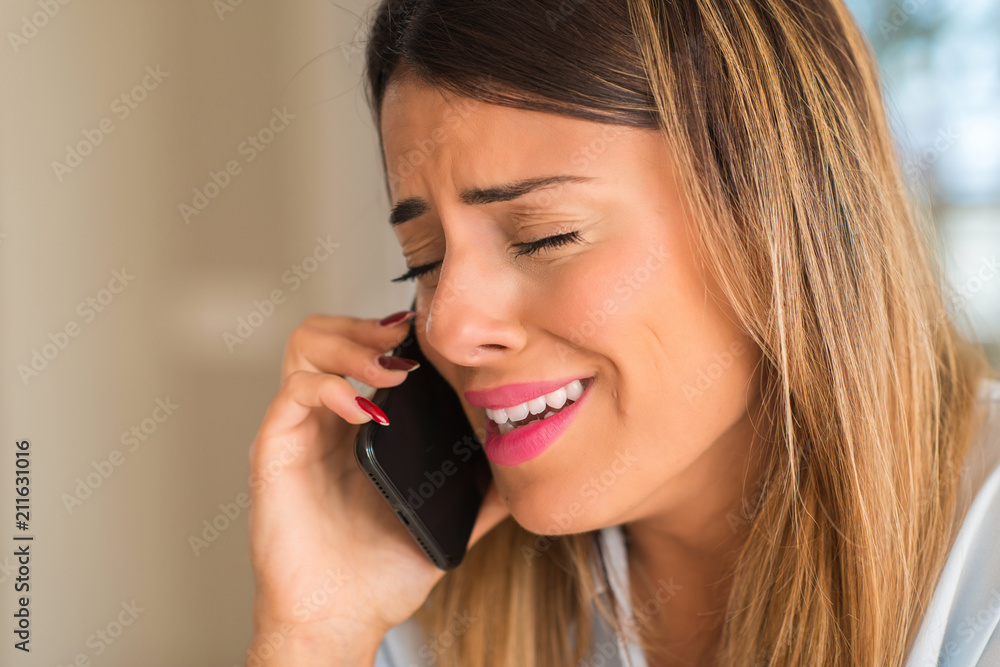 Sad woman talking on the smartphone, depressed and crying. Breaking off Sad woman talking on the smartphone, depressed and crying. Breaking off