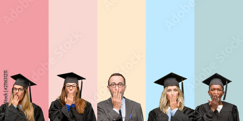 Photos Senior teacher with his graduate students covers mouth in shock, looks shy, expr