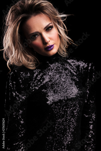 beautiful woman in black gleaming dress with purple lipstick