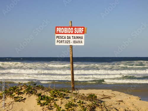 Florianopolis, Brazil - Circa May 2018: Sign at Santinho beach informing that Surfing is forbidden in the mullet season © Helissa