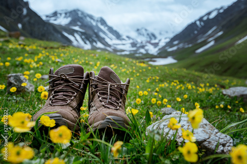 Pair of hiking boots lying in the grass