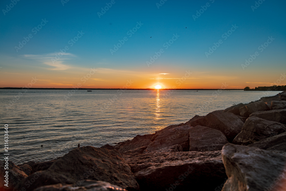Sunset over Lake with a Rock Shoreline