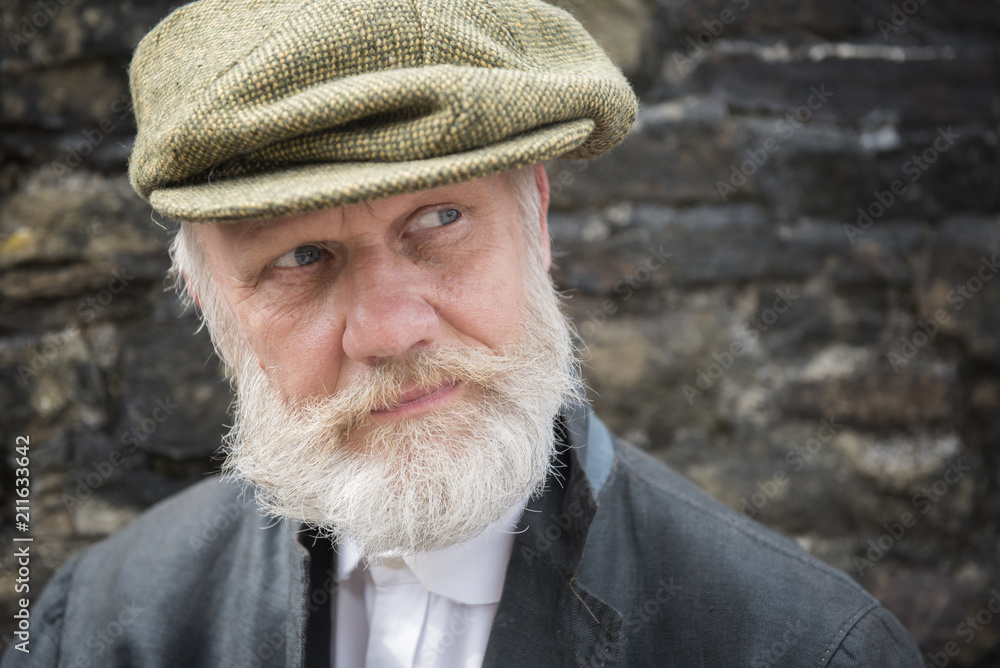 Mature man with white beard and moustache in flat cap Mature man with white beard and moustache in flat cap