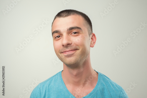 Closeup portrait of smiling man in blue t-shirt. Positive facial emotion