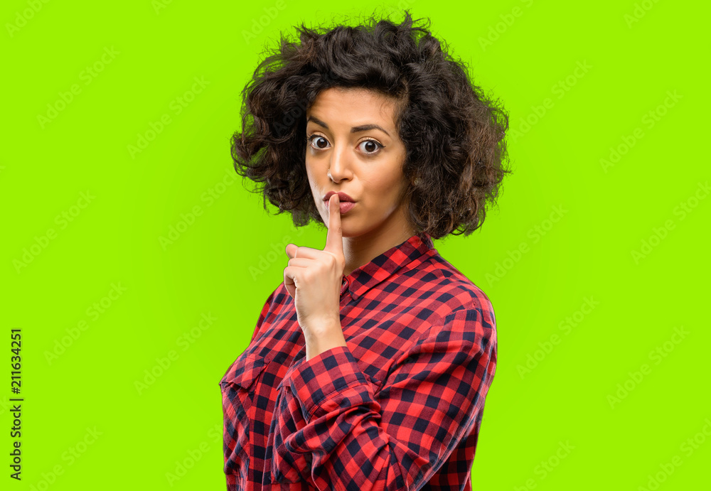 Beautiful arab woman with index finger on lips, ask to be quiet. Silence and secret concept Beautiful arab woman with index finger on lips, ask to be quiet. Silence and secret concept