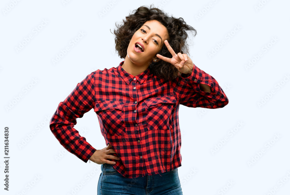 Beautiful arab woman looking at camera through fingers Beautiful arab woman looking at camera through fingers