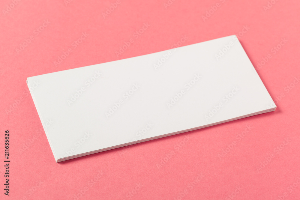 Blank paper pieces on a colored pink background Blank paper pieces on a colored pink background