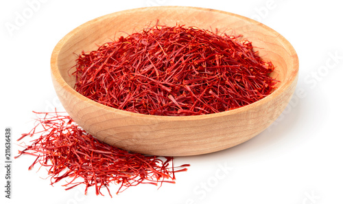 saffron thread in the wooden bowl, isolated on white background