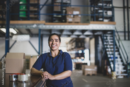 Portrait of female working in packing warehouse photo