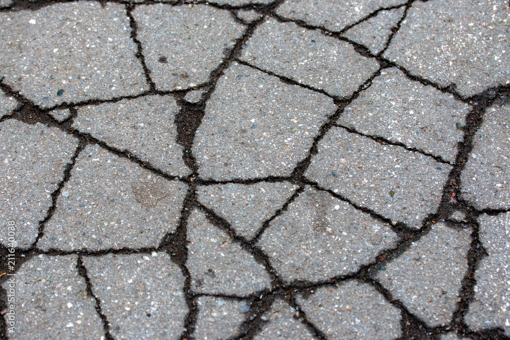 Obraz premium asphalt on the road is covered with cracks