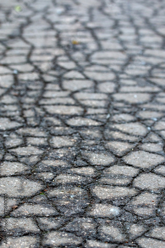 asphalt on the road is covered with cracks