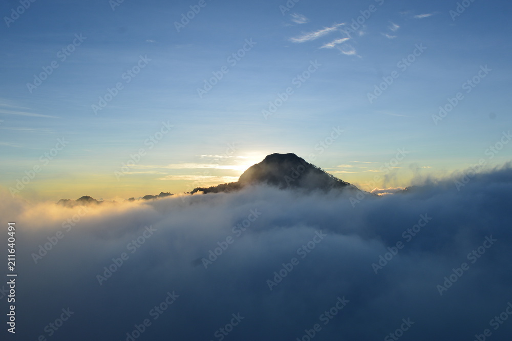 Sun Behind The Mountain Covered with Fog