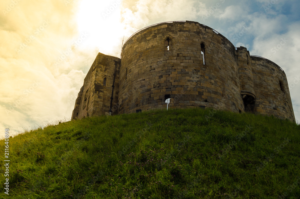 Clifford Castle in the city of York, England. Ruins of the tower suitable to visit with beautiful sky during a sunset. Clifford Castle in the city of York, England. Ruins of the tower suitable to visit with beautiful sky during a sunset.