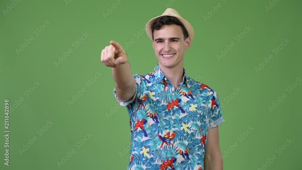 Young handsome tourist man pointing finger Young handsome tourist man pointing finger
