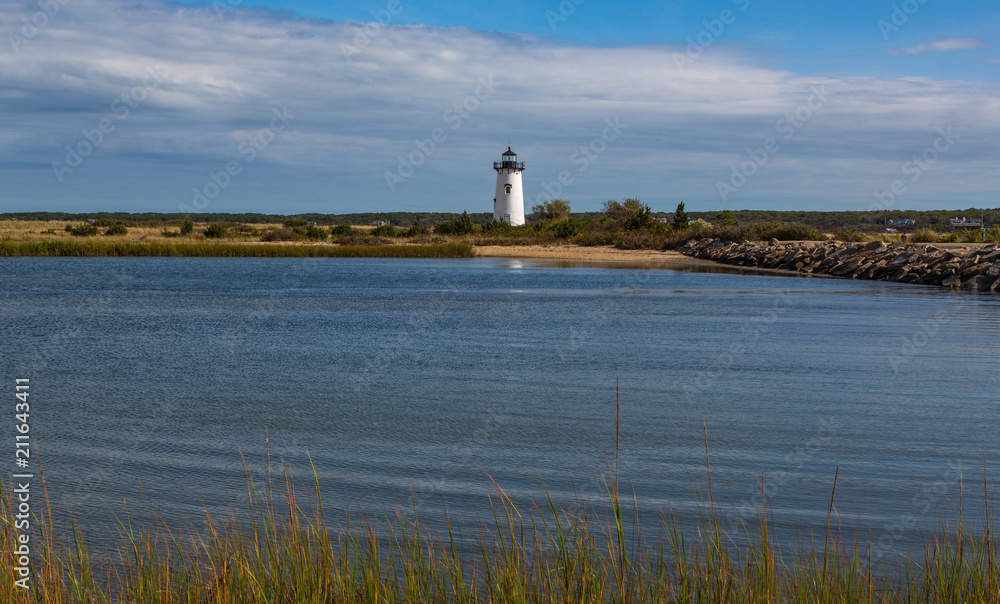 Lighthouse on sunny day across inlet
