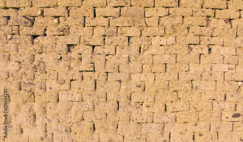 Pared para fondo o textura de ladrillos ( adobe ) de barro y paja  cocido al sol , con piedras incrustada photo