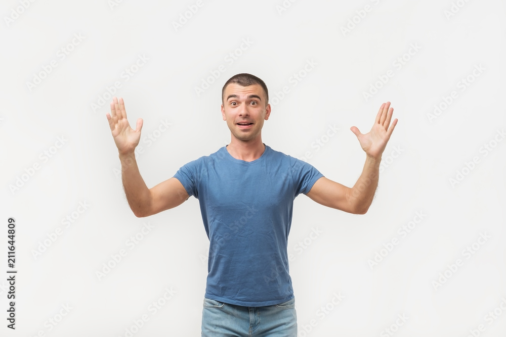 Naklejka premium Happy young hispanic man bragging about the big size of something. He is showing huge size of benefits.