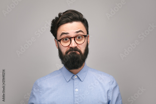 Doubtful hipster in glasses