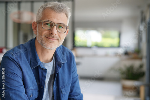 Middle-aged guy with eyeglasses and blue shirt photo