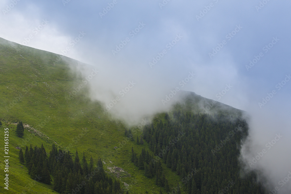Summer scenery in the Alps with rain and mist clouds
