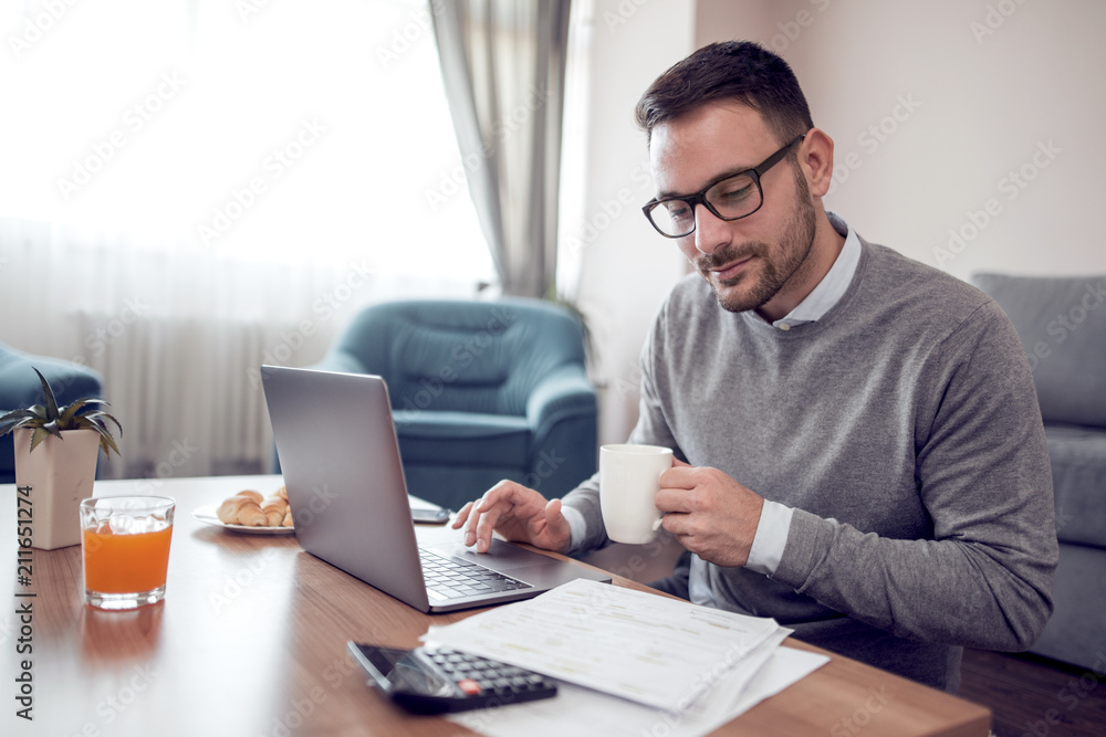 Man at home working on a laptop Man at home working on a laptop