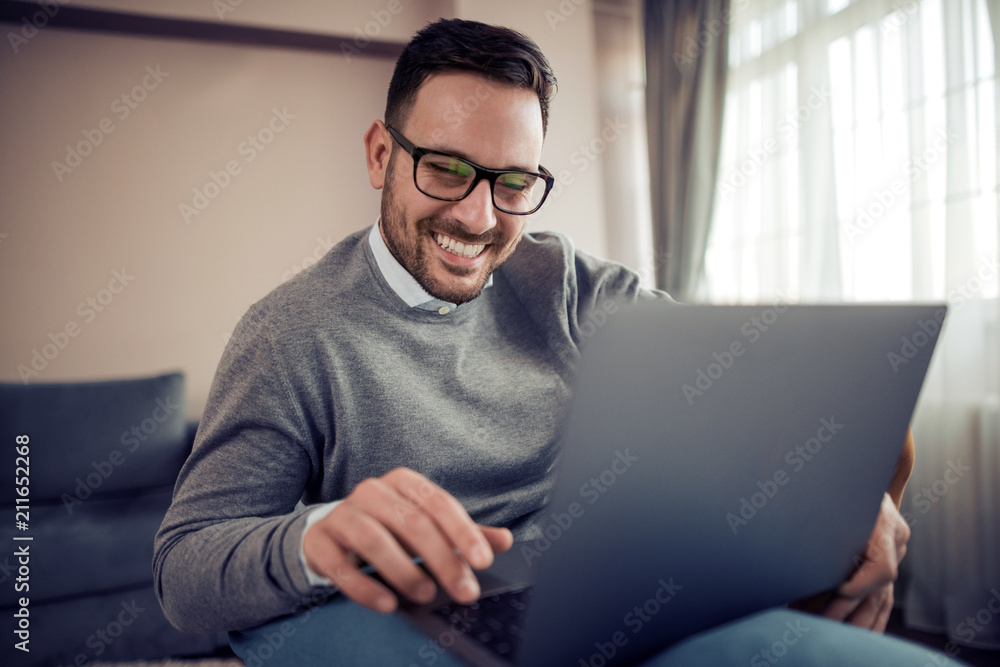 Handsome man working at home in a living room Handsome man working at home in a living room