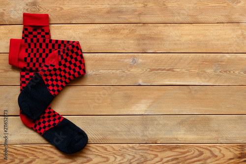 Pair of colorful socks on a wooden background.