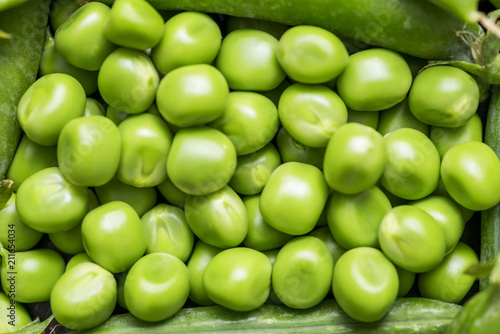 Green pea pod, green peas. Many fresh green peas as background