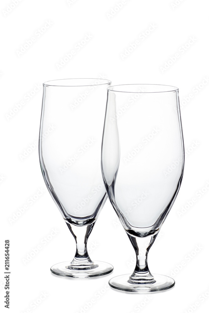 Two empty beer glasses on white