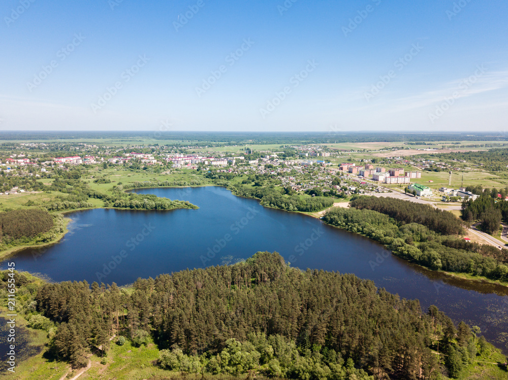 Beautiful aerial view of blue lake and green forest district in 
