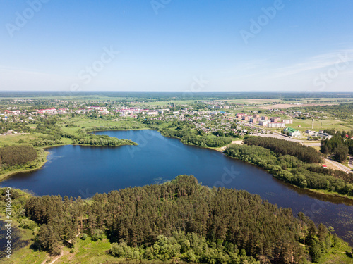 Beautiful aerial view of blue lake and green forest district in 