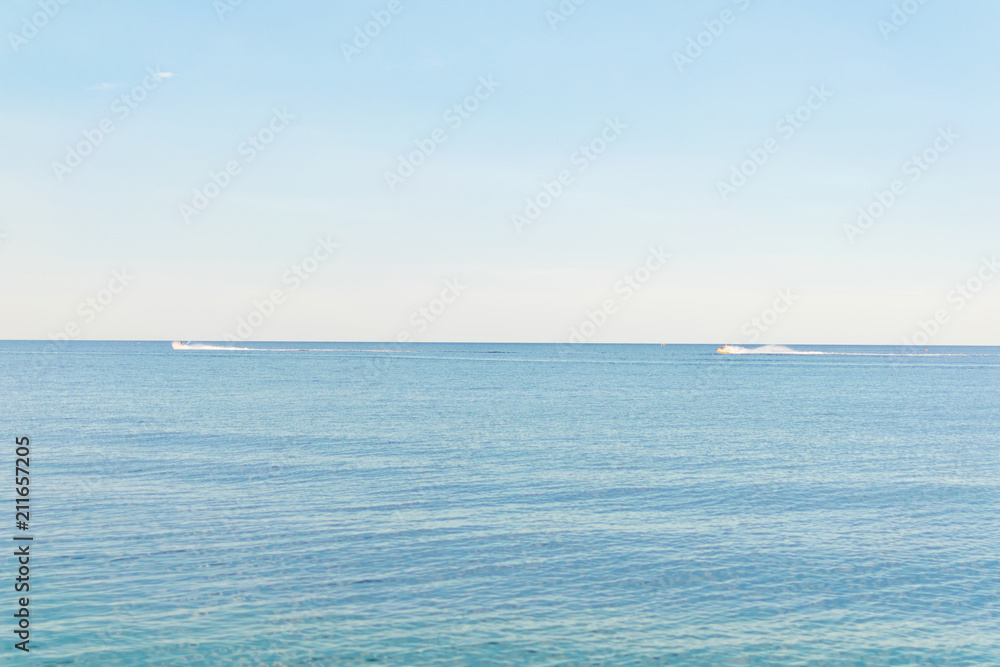 View of the sea with scooters floating in the distance. View of the sea with scooters floating in the distance.