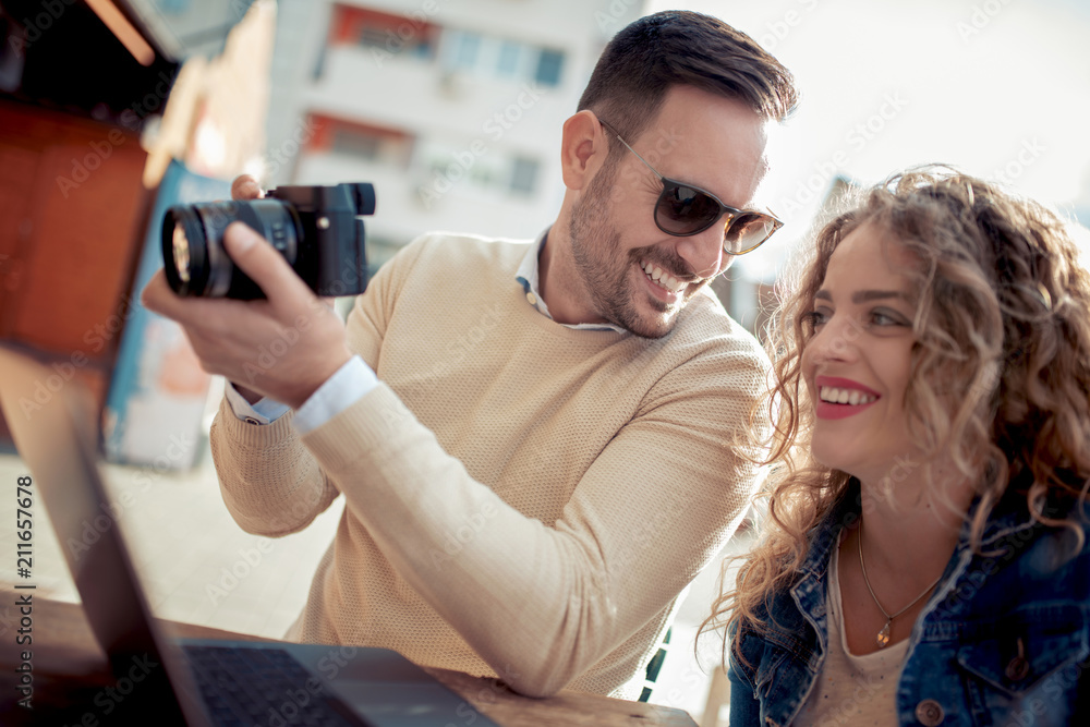 Couple watching pictures on camera Couple watching pictures on camera