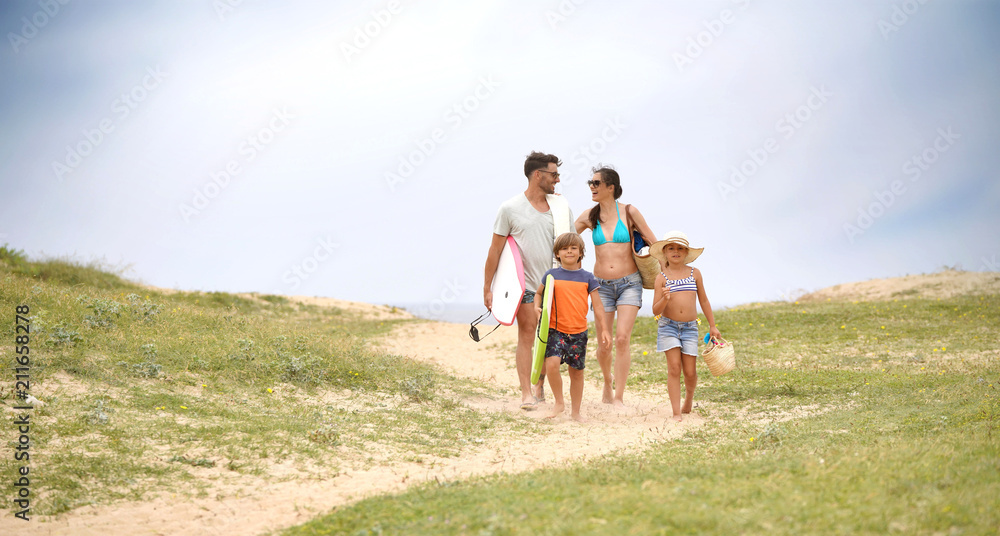 Family walking to the beach, sand dune path Family walking to the beach, sand dune path