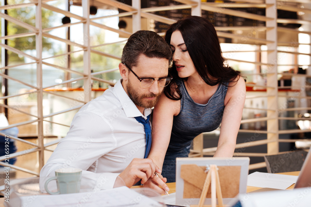 Art of seduction. Inspired dark-haired woman seducing her boss while  standing at his table Stock Photo | Adobe Stock