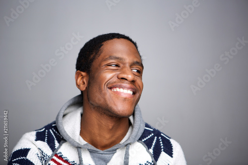 young african american man laughing against gray background