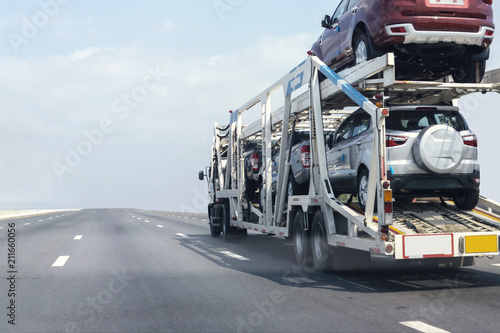 Trailer transport cars on the highway.Truck on highway road container, transportation concept.,import,export logistic industrial Transporting Land transport on the expressway.soft focus of cars © BigBlues
