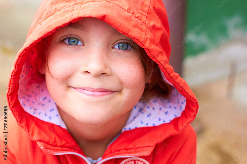 A cheerful little girl to a jacket and a hood. A cheerful little girl to a jacket and a hood.