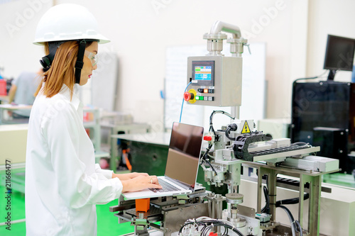 Female Engineer Using CAD Programming Software On Laptop