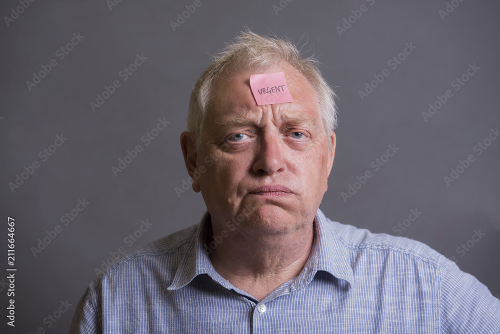 Tired and stressed mature man on a grey background Tired and stressed mature man on a grey background
