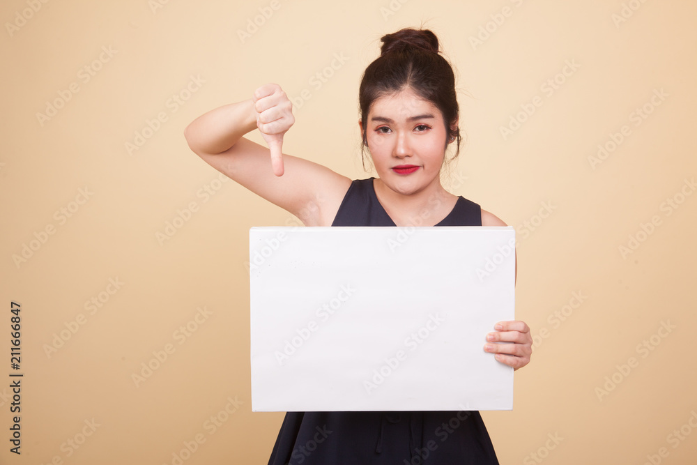 Young Asian woman show thumbs down with white blank sign. Young Asian woman show thumbs down with white blank sign.