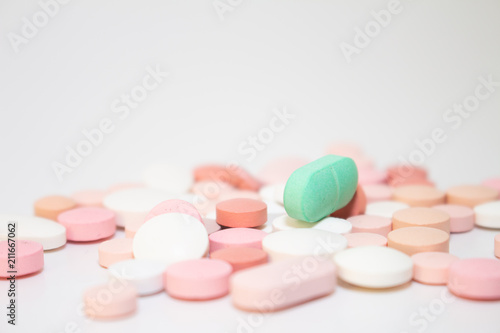 Numerous medicines Medications in the form of tablets. Colored pills on a white background.