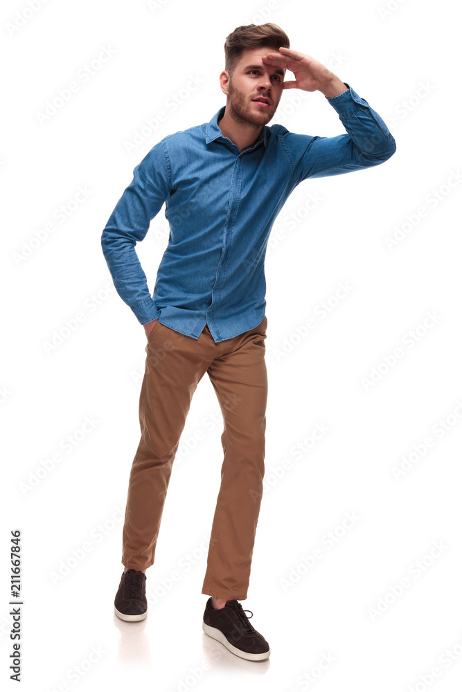 curious casual man looking to side in the distance curious casual man looking to side in the distance