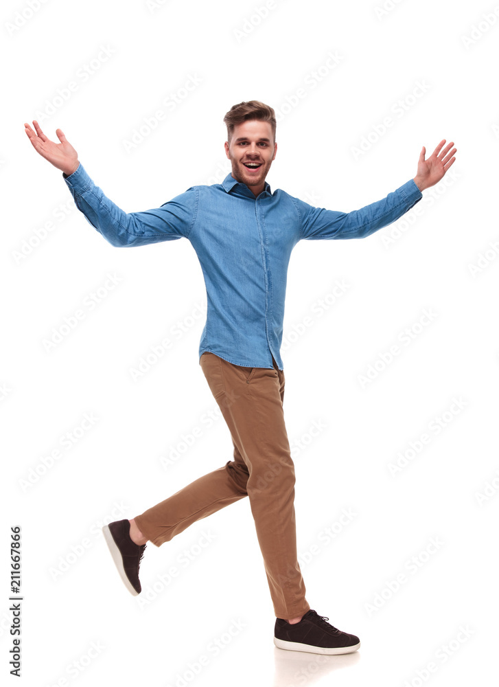 celebrating casual man with blue shirt walks to side