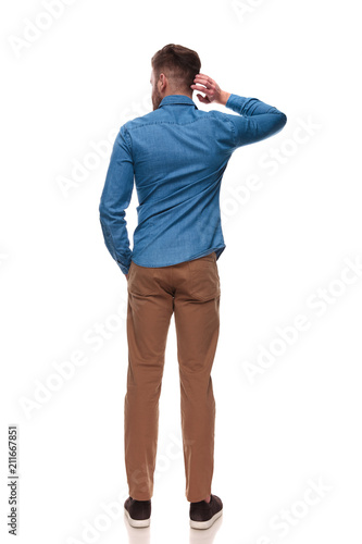 back view of relaxed casual man scratching his head