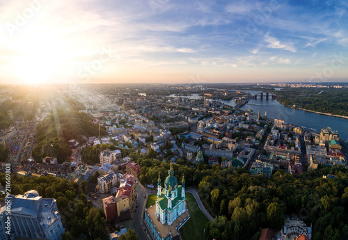 Panorama of the city of Kiev with the domes of St. Andrew's Church in the foreground, the historic district of Podol and the Dnieper River in the background. Cityscape